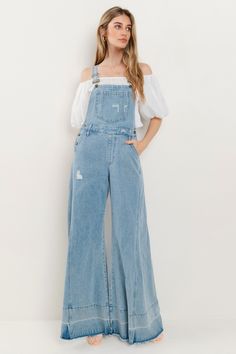 Choose comfort and style with the Women's Distressed Wide Leg Denim Overall. The adjustable straps, kangaroo chest pocket, and front and back pockets provide convenience, while the wide western legs, side buttons, and distressed accents add a trendy touch. Stay on trend in these comfortable, boho-inspired overalls. 34" INSEAM SLEEVELESSBUCKLE CLOSUREADJUSTABLE STRAPSKANGAROO CHEST POCKETFRONT/BACK POCKETSWIDE LEG Dark Wash Wide Leg Overalls With Pockets, Wide Leg Light Wash Overalls With Pockets, Relaxed Fit Full-length Denim Jumpsuit With Pockets, Wide Leg Dark Wash Overalls With Pockets, Casual Full-length Denim Jumpsuit With Pockets, Light Wash Denim Jumpsuit With Pockets, Spring Utility Jeans With Bib Front, Medium Wash Denim Jumpsuit With Adjustable Straps, Relaxed Fit Medium Wash Overalls With Adjustable Straps