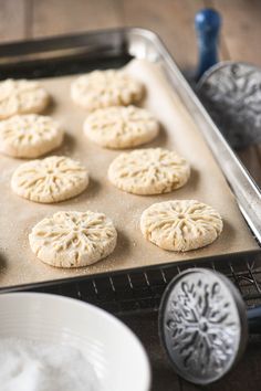 some cookies are sitting on a cookie sheet and ready to be baked in the oven