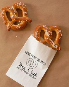 two pretzels sitting on top of a brown paper bag next to each other