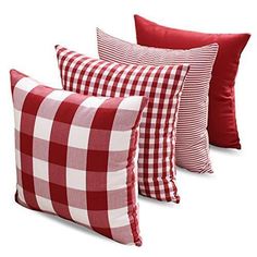 four red and white checkered pillows sitting next to each other