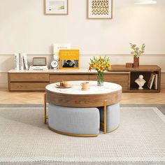 a living room with a coffee table and two chairs in it's center area