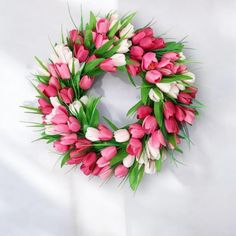 a wreath with pink and white tulips on it