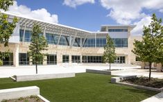 a building with grass and trees in front of it