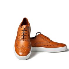 For The Man Who Believes That Style Doesn't Have To Be Boring, This Pair Of Light Brown Brogue Sneaker Is The Perfect Choice. It Lace Less Style Makes It Easy To Take On For A Business Casual Weekend As Well The Office Casual Lace-up Oxfords With Contrast Sole, Casual Brogue Leather Lace-up Shoes, Casual Wingtip Lace-up Shoes With Contrast Sole, Casual Lace-up Wingtip Shoes With Contrast Sole, Slip-on Brogue Leather Low-top Shoes, Slip-on Low-top Leather Shoes With Brogue Detailing, Brown Slip-on Sneakers For Derby, Casual Low-top Oxfords With Brogue Detailing, Casual Lace-up Shoes With Brogue Detailing And Round Toe