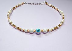 This beautiful necklace is handmade with round pearl beads, gold seed beads, and a beautiful turquoise and white evil eye. It is approximately 14 inches long and comes with additional extender chain, making it easily adjustable. The pearls reflect the light beautifully, making this a great summer necklace. Reach out with any questions! White Bohemian Beaded Necklace With Evil Eye, Bohemian White Beaded Necklace With Evil Eye, Adjustable White Beaded Necklace With Evil Eye, White Bohemian Necklace With Evil Eye, Bohemian White Necklace With Evil Eye Detail, Bohemian White Evil Eye Necklace, White Evil Eye Jewelry For Festivals, White Evil Eye, Pearl Necklace Gold