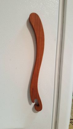 a wooden door handle on the side of a white door