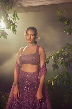 Featuring a argyle purple tulle lehenga embroidered fully by hand with various ornamental metallic sequences and Japanese bugle beads. It is paired with a scallop dupatta and a stylised blouse .From Aneesh Agarwaal's Ellora collection.DELIVERY TIMEPlease allow 8-12 weeks for your outfit to arrive.FABRIC DETAILSNetProfessional cleaning only. Tulle Lehenga, Scallop Dupatta, Purple Lehenga, Purple Tulle, Cutout Blouse, Padded Blouse, Embroidered Lehenga, Chaniya Choli, Bugle Beads