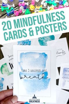 someone holding up some cards with the words, 20 mindfulness cards and posters