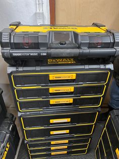 a large stack of tool boxes sitting next to each other