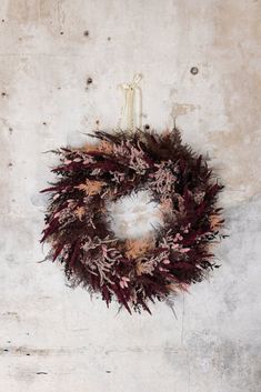 a dried wreath hanging on the wall