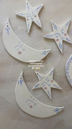 three ceramic moon and star decorations on a table