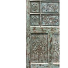 an old wooden door with decorative designs on it