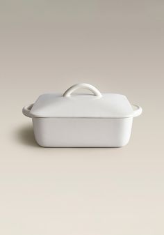 a white casserole dish sitting on top of a table