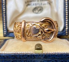 This item measures approximately :- U.K. size - 'S' and a half. U.S. size - '9.75' It weighs approximately - 6.45gms. It is a beautiful antique 9ct pale rose gold engraved decoration buckle ring.  Its fully English hallmarked for 375 9ct gold date mark for 1908.  Wear and tear expected on an antique /vintage item.  Box in photographs not included in the sale.  Please see photos for a more accurate description. Buckle Ring, Signet Rings, Gold Engraving, Signet Ring, Belt Buckle, Antique Vintage, Belt Buckles, Hallmark, Halloween Shopping