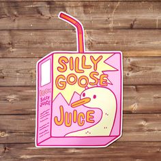 a sticker that says silly goose juice on the side of a wooden wall with wood planks behind it