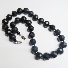 On offer is this Antique Victorian Black Mourning Whitby Jet Graduated Necklace that has been expertly hand carved into huge half inch diameter Whitby gems that gleam and catch the light. Whitby Jet was brought to the attention of the world by Queen Victoria who used Whitby Jet as part of her mourning attire. Today, genuine Antique Whitby Jet is highly collectable and sought after world wide. This necklace features beautifully faceted gems with a very high reflective polish of the blackest of bl Luxury Faceted Beaded Necklace For Formal Occasions, Formal Round Necklace With Polished Beads, Luxury Formal Faceted Beaded Necklaces, Formal Round Polished Beads Necklace, Luxury Formal Faceted Beaded Necklace, Luxury Round Faceted Necklaces, Formal Polished Round Bead Jewelry, Formal Round Polished Bead Jewelry, Round Faceted Beads Necklace For Formal Occasions