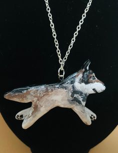 a necklace that has a dog on it