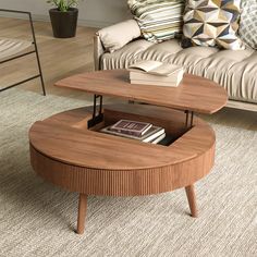 a living room with a couch, coffee table and books on the end tables in it