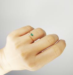 Two-Stone emerald/diamond ring is made of 14K solid Gold and weighs around 1 gram. The diamond is pear shape, weighs 0,04 carats and the emerald is around 0.15 carats.  Perfect gift for her to wear on all occasions.  Same design with ruby and blue sapphire is also available Ruby / Diamond: https://www.etsy.com/listing/914344987/twisted-diamond-ruby-ring-ruby-gold-ring?ref=shop_home_active_1&frs=1 Blue Sapphire / Diamond:https://www.etsy.com/listing/911168077/twisted-diamond-sapphire-ring-blue?re Green Wedding Ring With Single Diamond, Green Pear-shaped Diamond Ring For May Birthstone, Green Ring With Single Diamond In Fine Jewelry Style, Green Diamond Ring In Fine Jewelry Style, Green Single Diamond Promise Ring Jewelry, Green Single Diamond Jewelry For Promise Ring, Emerald Ring With Single Diamond For Anniversary, Green Single Diamond Promise Ring, Green Promise Ring With Single Diamond