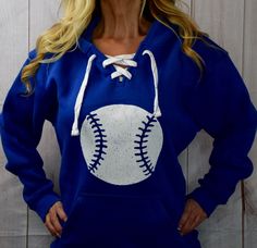 "Baseball Lace Up Hooded Sweatshirt. Baseball Shirt Mom Fashion. Baseball Sweatshirt. Sports Hoodie. T-Ball. Softball. Rain Dancer Clothing Best. Hoodie. Ever. Simple eroded baseball design that shows your love for the game. Super cute to wear while watching your little one from the sidelines or at a baseball game. Tells the world I am a baseball mom without really having to say it. This eroded vintage looking baseball design is screen printed with white ink on to a lace up sweatshirt that is su Best Hoodie, Baseball Fashion, Baseball Sweatshirts, T Ball, Dancers Outfit, Mom Fashion, Baseball Design, Sports Hoodies, Baseball Shirt