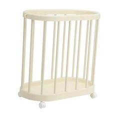 a small white crib with wheels on the bottom and sides, against a white background