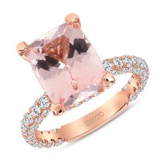 a pink diamond ring with diamonds around it