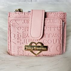 -Pink Card Wallet With "Juicy Couture" Embossed All Over It And Has Gold "Juicy Couture" Logo Charm On The Front -Has 3 Card Holders,Id Slot, And Zippered Coin Pocket -Had Buttoned Tab Closure -All Gold Hardware Accents -New With Tags. No Damages Dimensions W:5" H:3½" Trendy Pink Rectangular Wallets, Compact Pink Card Holder With Card Slots, Pink Card Holder With Zipper Closure As Gift, Trendy Pink Card Holder With Card Slots, Trendy Pink Wallet With Card Slots, Trendy Pink Wallets With Card Slots, Trendy Pink Compact Coin Purse, Juicy Couture Logo, Barbie Stuff