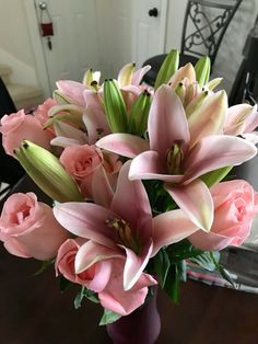 a vase filled with pink flowers on top of a table