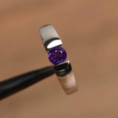 It is a natural amethyst ring. The main stone is 5 mm*5 mm round cut.weight about 0.48 carats.The basic metal is sterling silver and plated with rhodium.To change the metal to a solid gold (white/rose) or platinum is also available, please ask for a quotation if you want.You can also go to my shop Home for more elegant rings: https://www.etsy.com/shop/godjewelry?ref=hdr_shop_menu Amethyst is February birthstoneMore amethyst rings:https://www.etsy.com/shop/godjewelry?ref=seller-platform-mcnav&sec Minimalist Amethyst Birthstone Ring For Anniversary, Minimalist Amethyst Birthstone Promise Ring, Modern Round Birthstone Ring With Tension Setting, Purple Solitaire Birthstone Ring, Round Cut White Gold Amethyst Birthstone Ring, Minimalist Silver Amethyst Ring, Silver Amethyst Birthstone Ring, White Gold Amethyst Birthstone Ring With Round Cut, Amethyst Birthstone Ring In White Gold