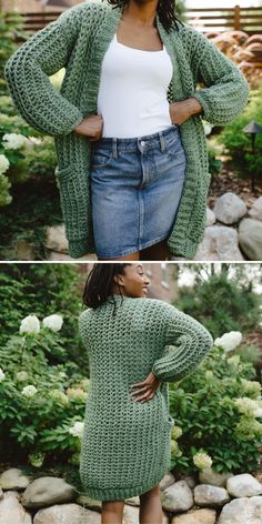 a woman wearing a green knitted cardigan standing in front of some rocks and bushes