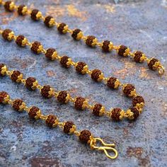 Beads is made using hand-picked, highest quality, smooth, hard, round and lustrous 5 mukhi Rudraksha beads from Java (Indonesia) along with a beautiful orange tassel. The mala can be worn or can be used for Mantra Japa. Benefits and Purpose: 5 mukhi Rudraksha beads enhances self-work and induce confidence 5 mukhi Rudraksha bead blesses the wearer with health, prosperity, and success The Mala increases concentration, memory and creativity The Mala helps aid meditation and Spiritual sadhana Size: Gold Mala With 8mm Beads For Meditation, Gold Hand-strung Mala For Meditation, Gold Mala With 108 Beads For Rituals, Temple Necklace With Latkans And Round Beads For Festivals, Festival Gold Beads Temple Necklace, Gold Mala With Tilla And Round Beads, Gold Temple Necklace With Gemstone Beads For Festivals, Festive Gold Beaded Temple Necklace, Spiritual Necklace With Latkans And Round Beads