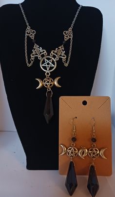 A lovely goddess necklace set. Triple moon and pentagram design, with black protection stone. Pentagram Design, Pentagram Necklace, Goddess Necklace, Triple Moon, Protection Stones, Necklace And Earrings Set, Necklace And Earrings, Earrings Set, Pendant Necklaces