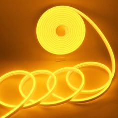 three yellow neon lights on a white surface