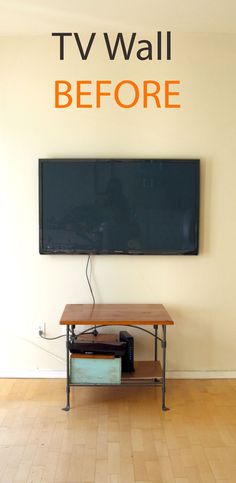 a television sitting on top of a wooden table in front of a flat screen tv