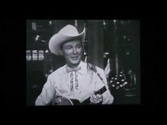 a man wearing a cowboy hat and holding a guitar