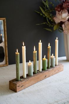 a group of candles sitting on top of a wooden stand