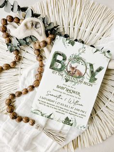 the baby shower is set on top of a white table cloth with beads around it