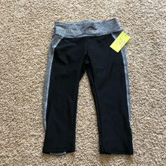 Never Been Worn Black Capri Leggings With Grey Trim Stretchy Wasteband Black Elastic Workout Leggings, Black Elastic Athleisure Leggings, Stretch Black Capris For Sports, Black Stretch Capris For Sports, Black Stretch Athleisure Capris, Black Stretch Capris For Yoga, Black Sporty Capri Length Leggings, Black Sporty Capri-length Leggings, Black Capri Length Athleisure Leggings