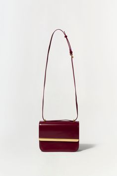 FALL 2024 WOMEN'S COLLECTION The Remy Bag in Oxblood. Featuring a sleek design and gold accent, add sophistication to your outfit with this elegant flap bag. Perfect for day-to-night transitions, it effortlessly combines style and functionality. SIMKHAI Women's Remy Bag in Oxblood Maxi Dress Wedding Guest, Oxblood Red, Swimwear Sets, Maxi Dress Wedding, Handbag Wallet, Knitwear Tops, Gold Accent, Your Outfit, Fall 2024