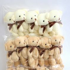 a bunch of stuffed teddy bears sitting on top of each other in a plastic bag