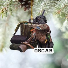 a black dog hanging from a tree with a duck in it's mouth and holding a purse