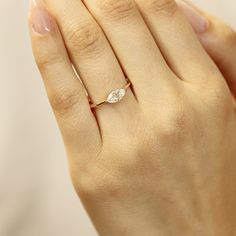 This stunning 14k gold ring features a beautiful marquise cut moissanite, measuring 8x4mm. DETAILS ABOUT THE RING, MATERIAL AND STONES Ring Band: 14K YELLOW GOLD Ring Band size: 1.2 mm thick Gemstone: Moissanite Moissanite size: 8x4mm marquise cut. (0.50 ct. ) D color *** All our raw materials are sourced from US-based companies for the quality and safety of our handmade products. *** this ring is handcrafted for you in our local studio in Redlands, California. We are a small workshop which spec Dainty Solitaire Marquise Cut Ring, Dainty Marquise Cut Ring With Single Diamond, Dainty Marquise Cut Yellow Gold Rings, Marquise Solitaire Diamond Ring As Gift, Gold Marquise Diamond Promise Ring, Marquise Yellow Gold Ring With Tension Setting, Promise Moissanite Marquise Wedding Ring, Marquise Diamond Ring Gift, Marquise Solitaire Yellow Gold Diamond Ring