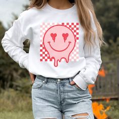 Retro Smiley Face sweatshirt, Distressed Vintage Look Smiley face, Crewneck sweatshirt, Retro smile, smile graphic sweater, valentines, melted smiley face, good vibes, positivity, Be Happy, Brahman Darlin Thank you for shopping my small business. Please message me if you have questions. This is a physical shirt that is made when you order it and shipped out to you. I do not sell my designs, they are made with love, by me to support my family's cattle ranch. If you love the design and would like Spring Grunge Crew Neck Sweatshirt, Casual Fall Tops With Heart Graphic, Casual Top With Heart Graphic For Fall, Long Sleeve T-shirt With Heart Graphic For Streetwear, Fun Cotton Tops For Leisure, Pink Casual Sweatshirt With Heart Graphic, Fall Streetwear Top With Heart Graphic, Casual Pink Sweatshirt With Heart Graphic, Trendy Long Sleeve Sweatshirt With Funny Print