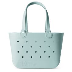 a blue tote bag with polka dots on the front and side, sitting against a white background