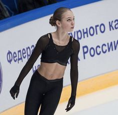 a female figure skating on an ice rink