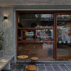 two wooden tables sitting in front of a window