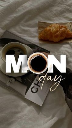 a cup of coffee and croissant on a bed with the words mom day