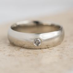 a wedding band with a diamond on it