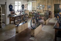 there are many bikes that are on display in this room with wood slats behind them