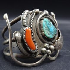 DESCRIPTION:  This fabulous Simplicio-era cuff features an outstanding specimen of natural blue turquoise, along with a glorious finger of old red Mediterranean branch coral.  Applied leaves, stamens, and raindrops accentuate the stunning gemstones.  This bracelet will be a cherished addition to your collection of fine vintage Southwestern and Native American jewelry. MEASUREMENTS: Interior of the cuff measures 5 5/8" with an additional 1" slightly adjustable gap. Total circumference:  6 5/8" Measures 2 3/8" straight across the widest part of the cuff (from wrist bone to wrist bone) Bracelet face measures  2" wide (the face of the bracelet, north to south) Cabochon measures 18mm x 14mm WEIGHT:  60.0 grams SIGNED:  no STERLING:  unmarked, verified sterling silver Jewelry Measurements, Bones Bracelet, Turquoise Bracelet Cuff, Turquoise Cuff, Coral Turquoise, American Jewelry, Native American Jewelry, Blue Turquoise, Vintage 1950s